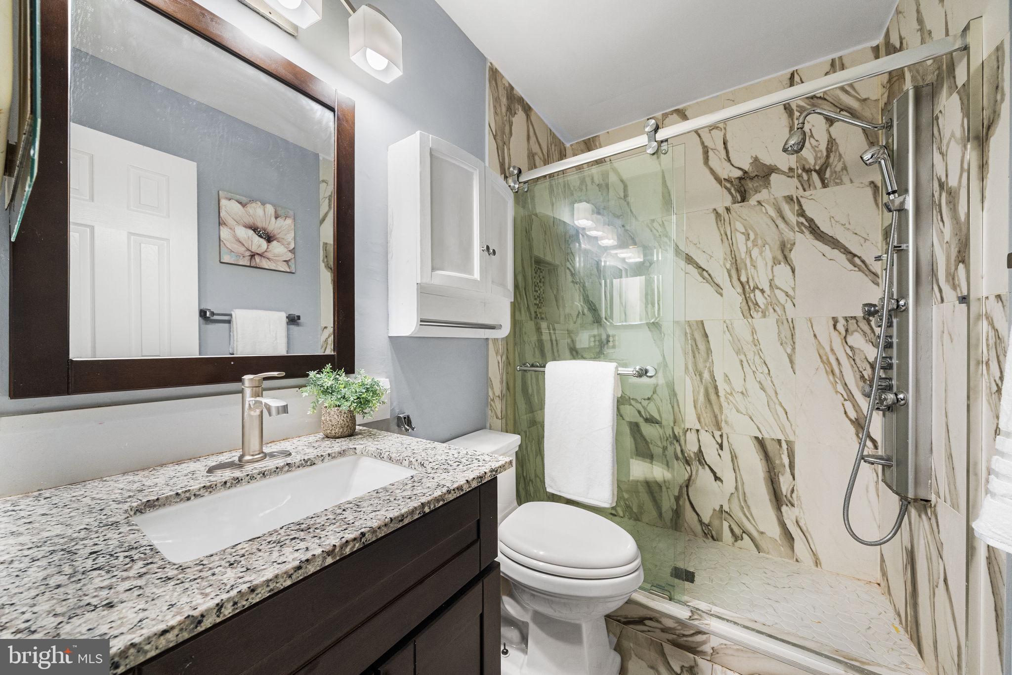 7403 Ridge Oak Court Springfield, VA 22153 - Photo 35 of 54 a bathroom with a granite countertop sink and a mirror