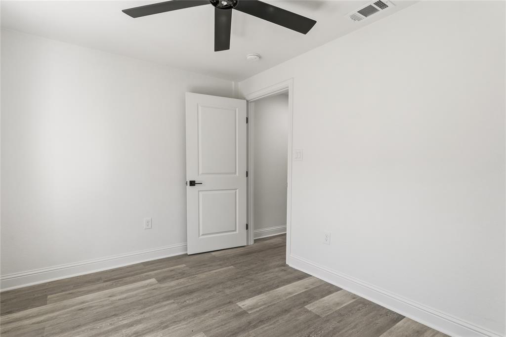 815 Garrison Street Waco, TX 76704 - Photo 26 of 36 an empty room with wooden floor ceiling fan and window