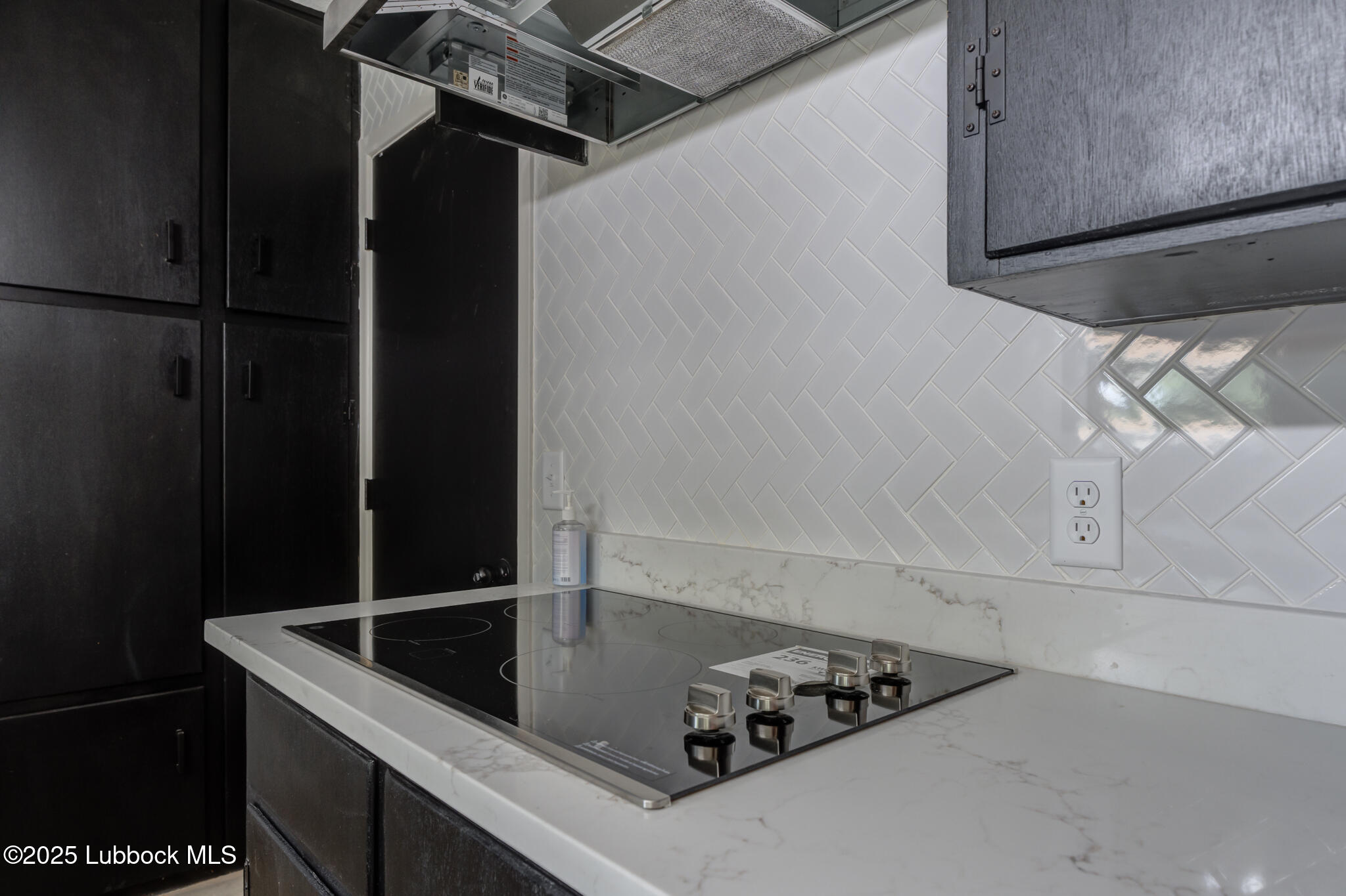 2803 West 18th Plainview, TX 79072 - Photo 14 of 32 a kitchen with a refrigerator and cabinets