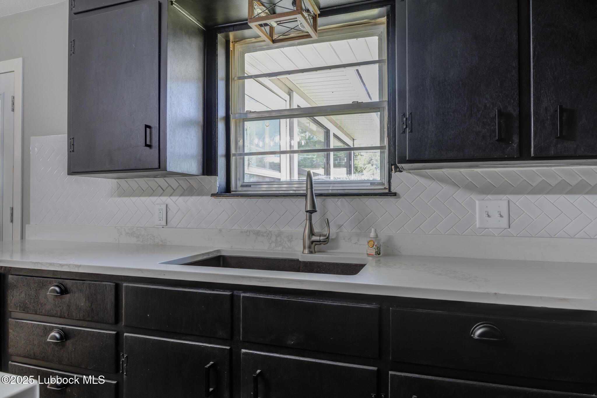2803 West 18th Plainview, TX 79072 - Photo 15 of 32 a kitchen with a sink and cabinets