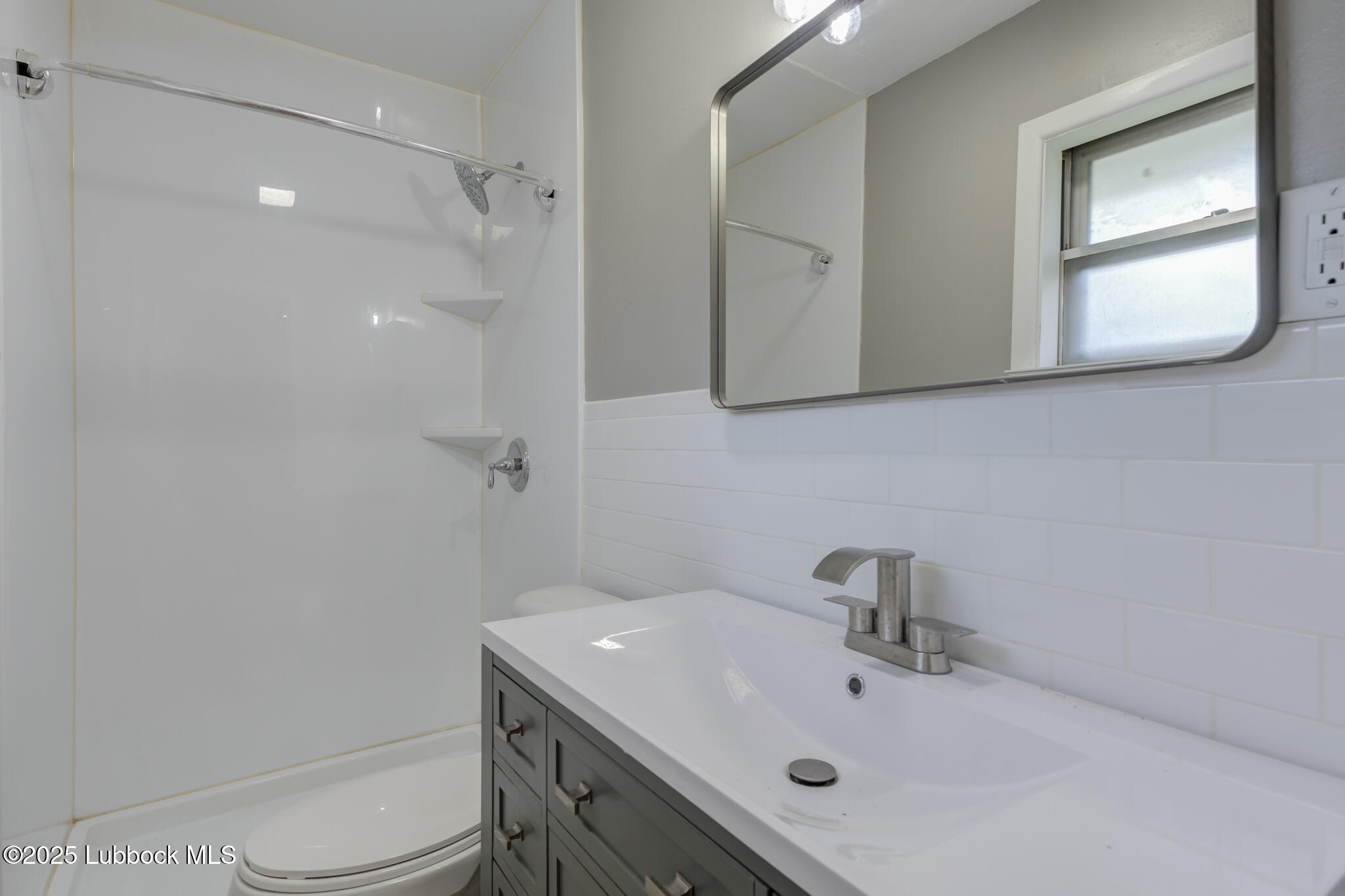 2803 West 18th Plainview, TX 79072 - Photo 23 of 32 a bathroom with a sink vanity and mirror