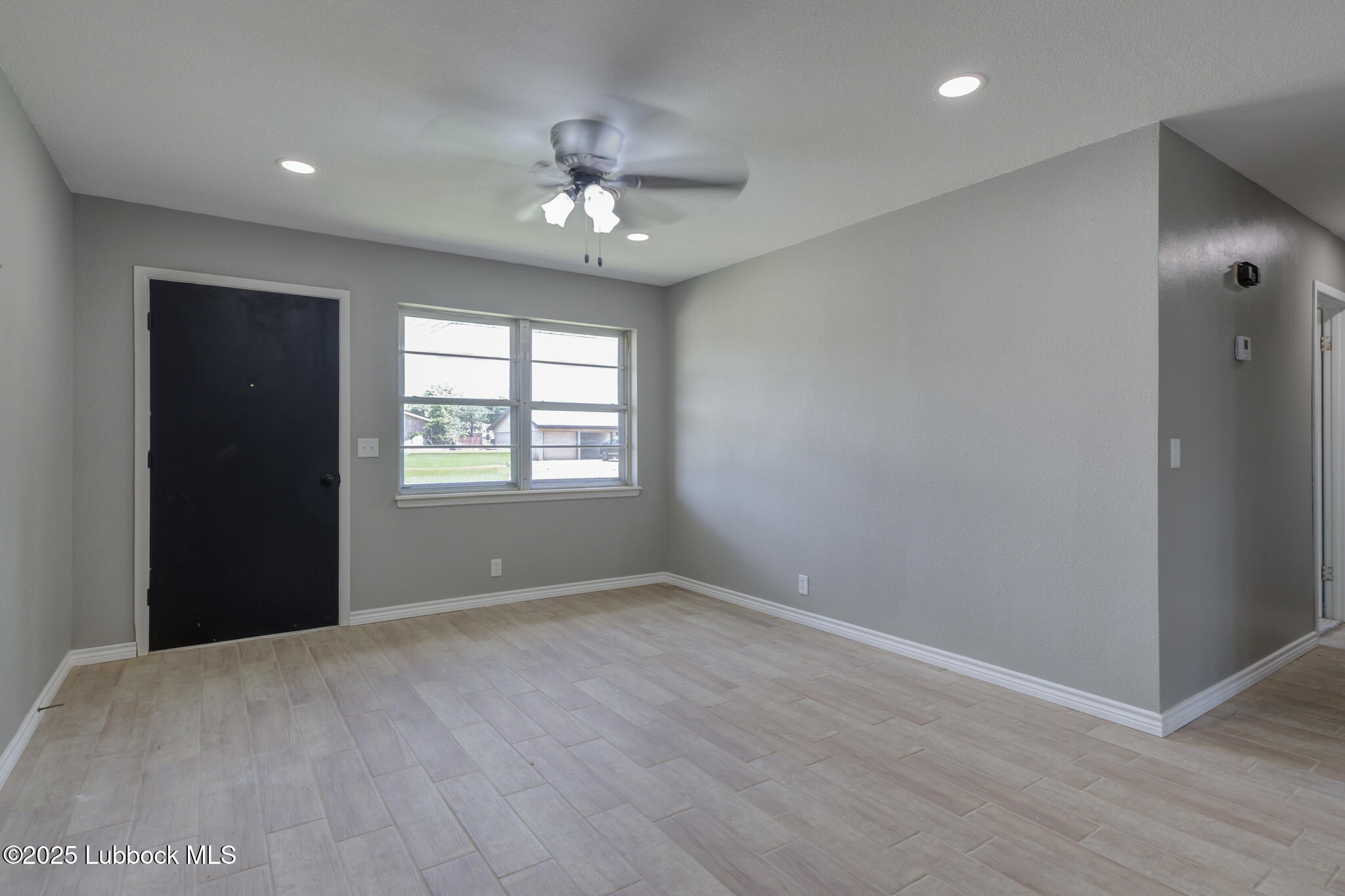 2803 West 18th Plainview, TX 79072 - Photo 5 of 32 a view of an empty room with a window