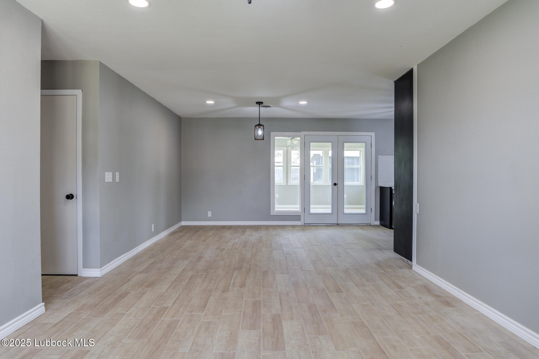 2803 West 18th Plainview, TX 79072 - Photo 8 of 32 wooden floor in an empty room with a window