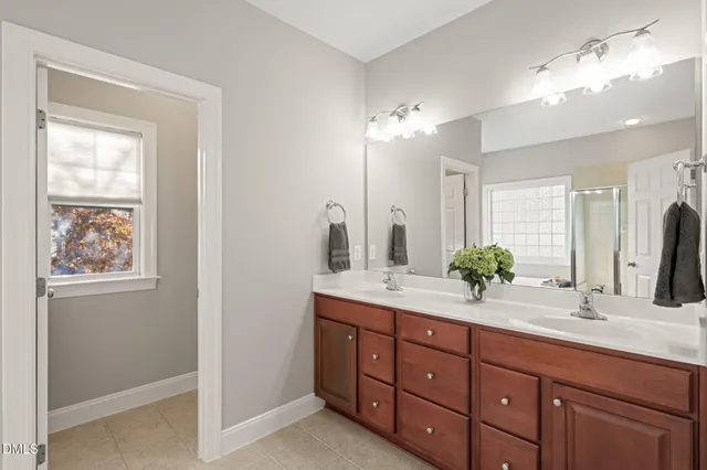 a bedroom with a bed couch and a large window