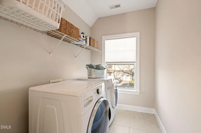 a bathroom with double vanity sink a vanity a lamp and a window