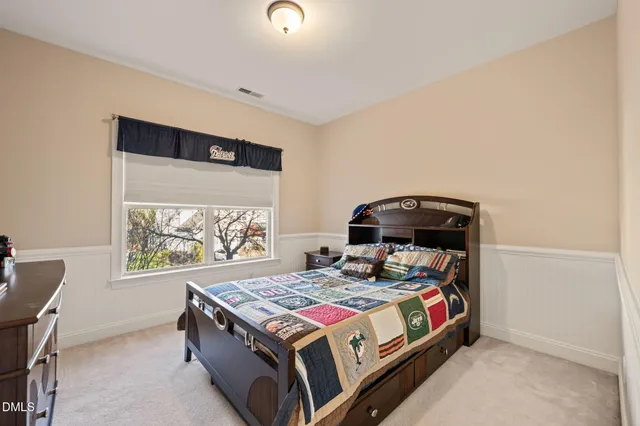 a bedroom with a bed and a lamp