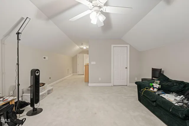 a view of a livingroom with furniture and a ceiling fan