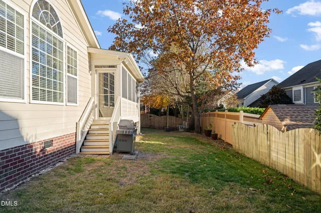 a living room with furniture a flat screen tv and a window