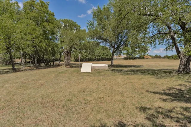 a swimming pool with trees in the background