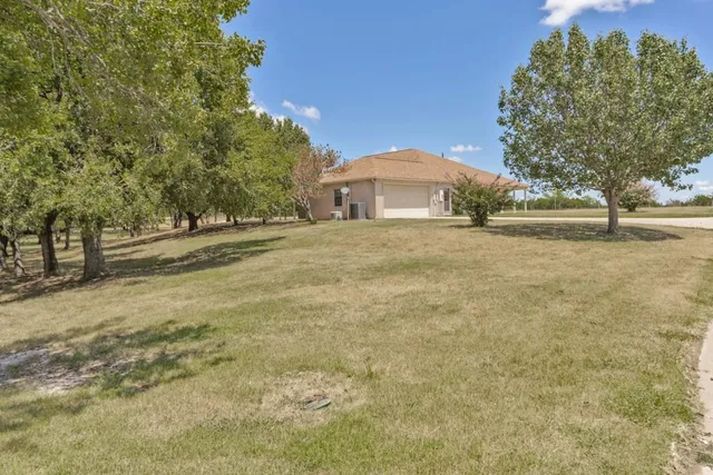 a view of a yard with an trees