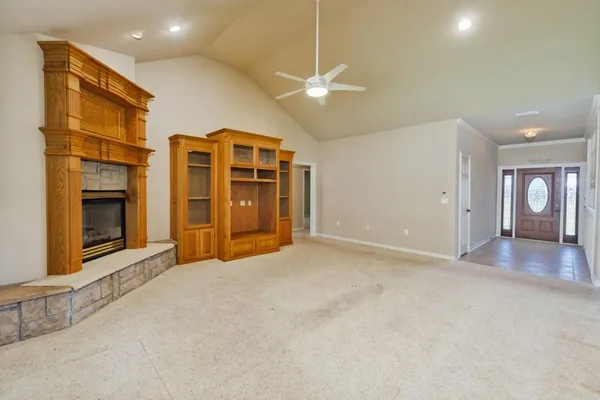 an empty room with windows and cabinet
