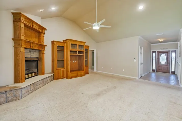 an empty room with windows and cabinet