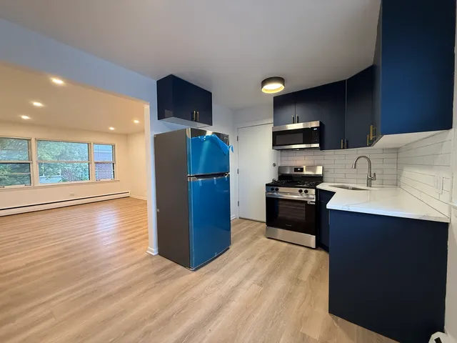 a kitchen with stainless steel appliances a refrigerator stove microwave and sink