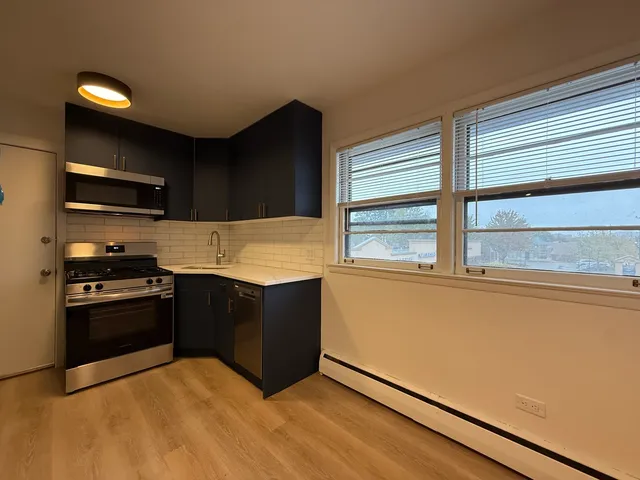 a kitchen with stainless steel appliances granite countertop a refrigerator and a stove top oven