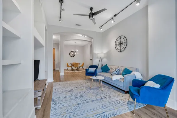 a living room with furniture and a wooden floor