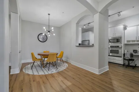 a view of a dining room with furniture wooden floor and a chandelier