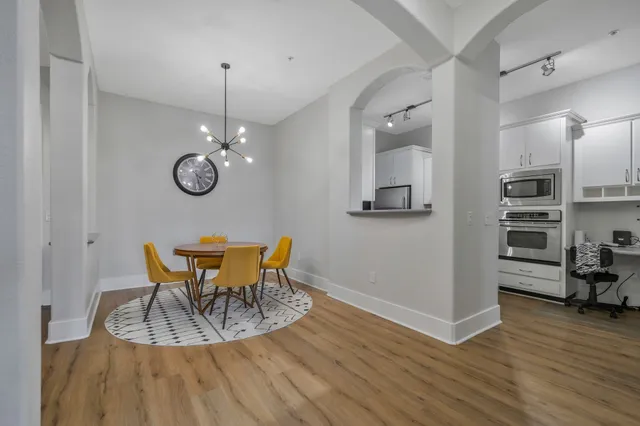 a view of a dining room with furniture wooden floor and a chandelier