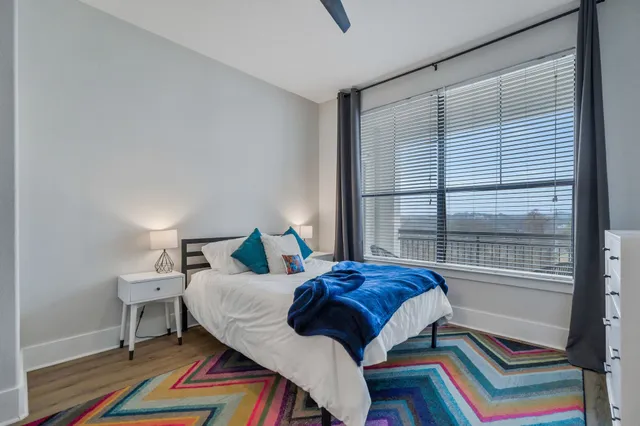 a bedroom with a bed and a window