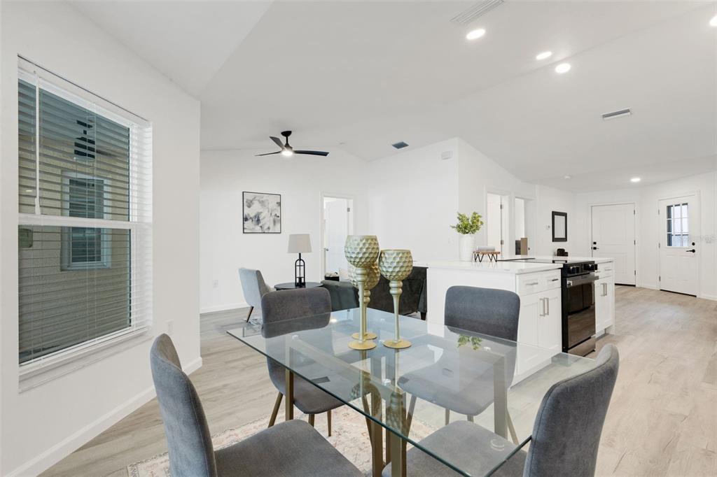 606 Marcus Street, Unit 26 Venice, FL 34285 - Photo 15 of 42 a view of a dining room with furniture and wooden floor