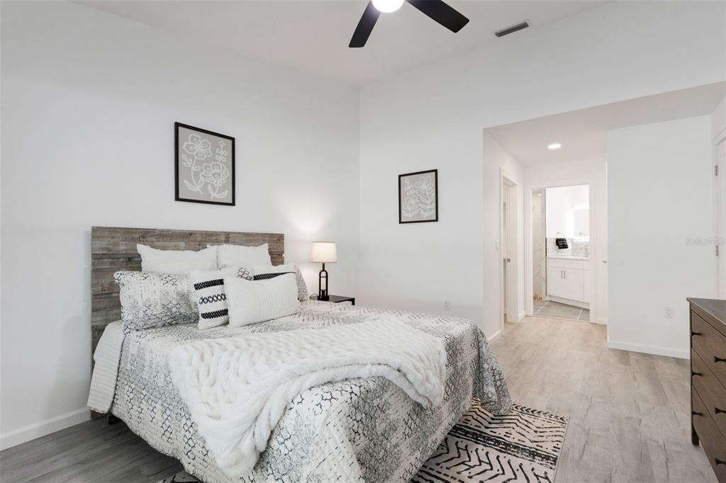 606 Marcus Street, Unit 26 Venice, FL 34285 - Photo 21 of 42 a bedroom with bed and night stand