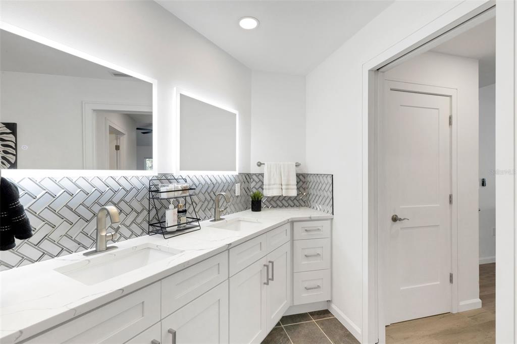 606 Marcus Street, Unit 26 Venice, FL 34285 - Photo 26 of 42 a bathroom with double sink and a mirror
