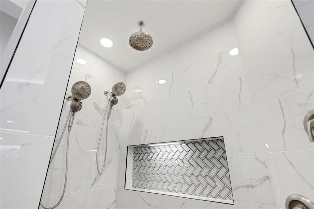 606 Marcus Street, Unit 26 Venice, FL 34285 - Photo 28 of 42 a bathroom with a shower and a mirror