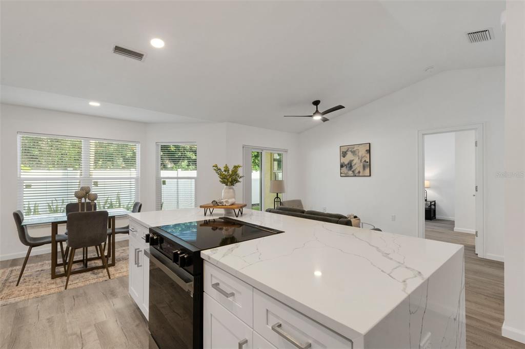 606 Marcus Street, Unit 26 Venice, FL 34285 - Photo 9 of 42 a kitchen that has a sink a table and chairs in it