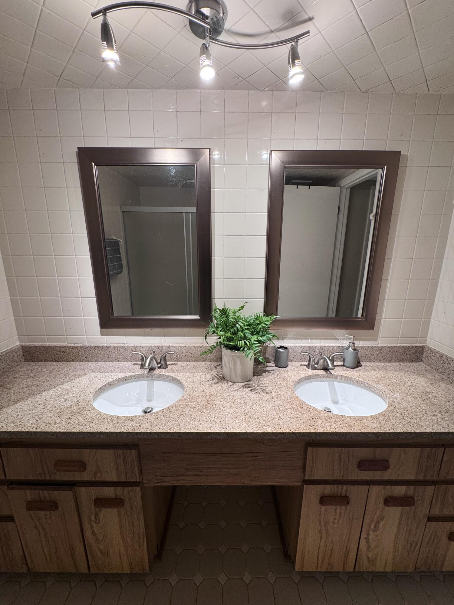 108 Lacosta Lane, Unit 611 Daytona Beach, FL 32114 - Photo 4 of 6 a bathroom with a sink and a mirror