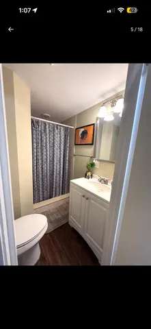 a bathroom with a toilet a sink and mirror