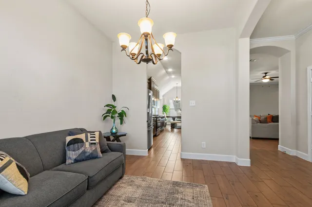 a living room with furniture chandelier and a chandelier