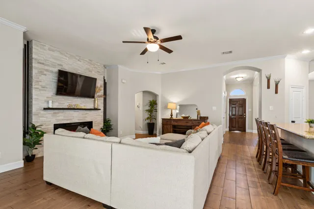 a living room with furniture fireplace and flat screen tv