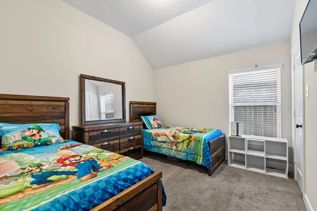 a bedroom with two beds and a window