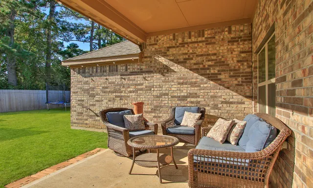 a view of a patio with couches chairs and a fire pit