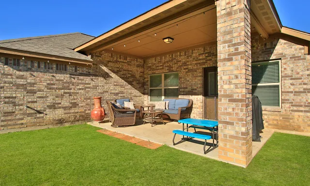 a view of a patio with a table and chairs