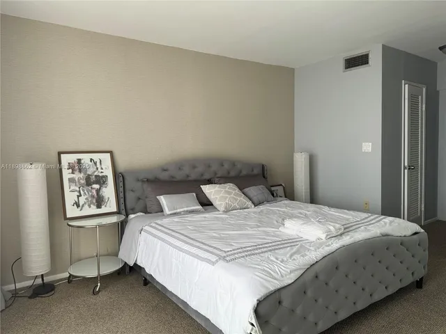 a bedroom with a bed and a wall painting