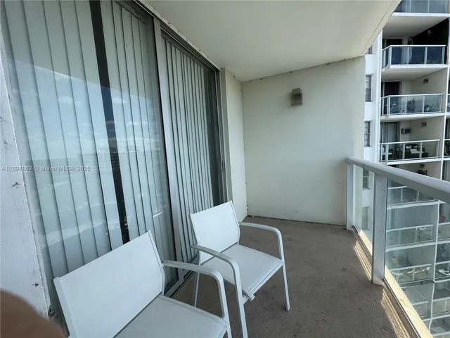 a view of room with stairs and wooden floor