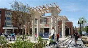 a view of a building with a fountain in a yard