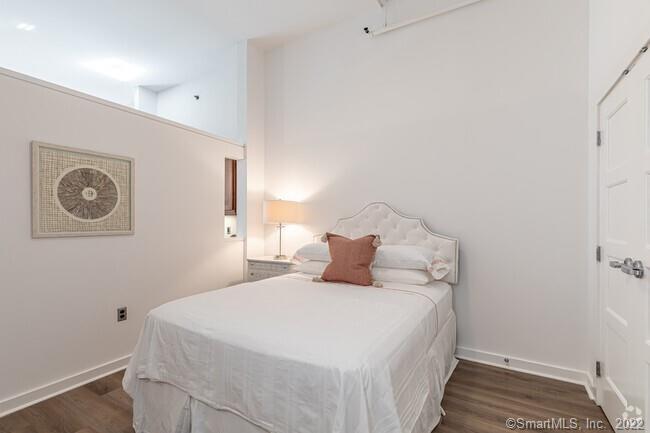 15 Dinah Road, Unit 313 West Hartford, CT 06107 - Photo 4 of 36 a bedroom with a bed and a lamp