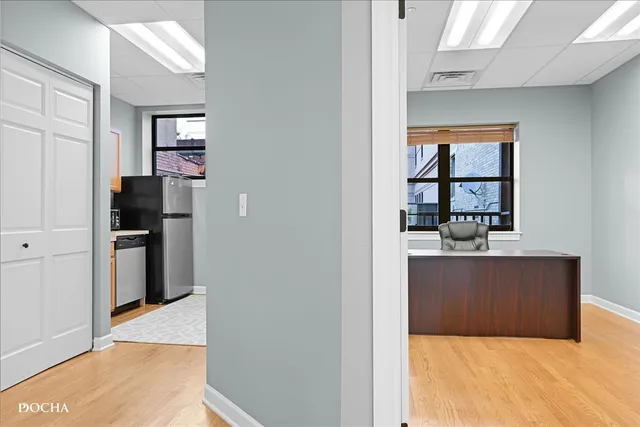 a view of kitchen with refrigerator and window