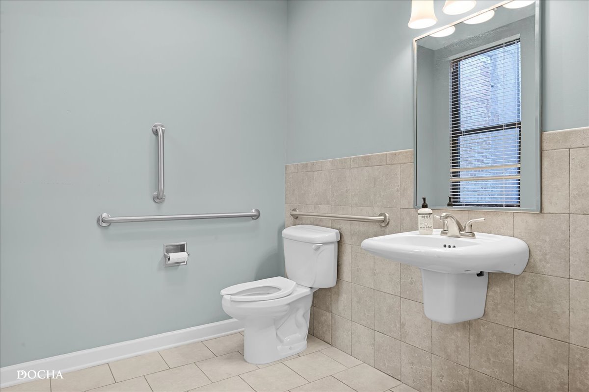 202 West Main Street, Unit 202 St. Charles, IL 60174 - Photo 14 of 17 a bathroom with a sink toilet and mirror