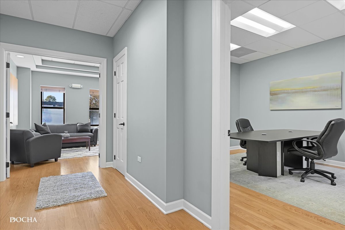 202 West Main Street, Unit 202 St. Charles, IL 60174 - Photo 4 of 17 a view of a workspace room with wooden floor and furniture