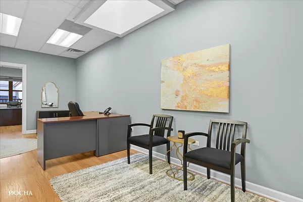 a work room with furniture and wooden floor