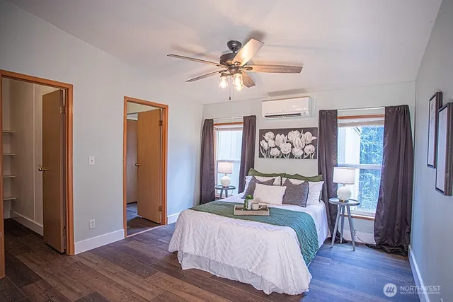 a bedroom with a large bed and a chandelier