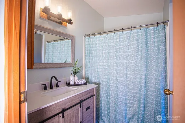 a bathroom with a sink a vanity and a mirror
