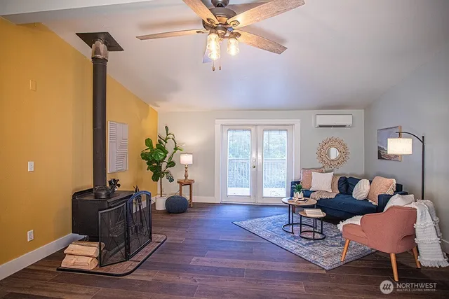 a living room with furniture a chandelier and a window