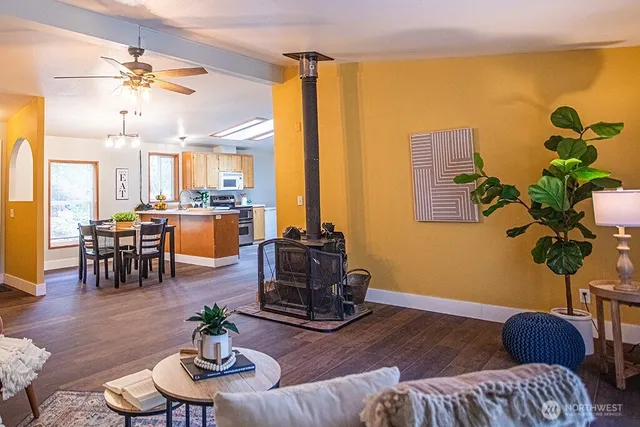 a living room with furniture potted plant and a large window