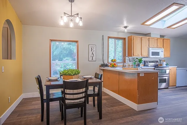 a dining room with furniture a window and wooden floor