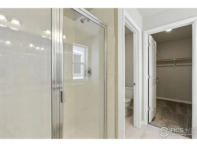 a bathroom with a glass shower door