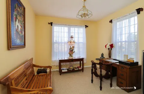 a view of a livingroom with furniture and a window