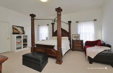 a bedroom with a bed couch and a window